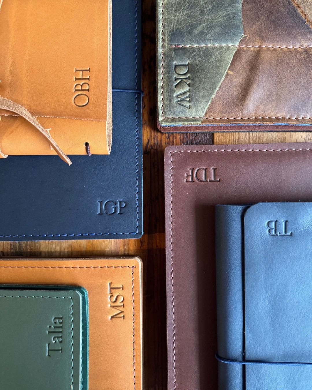 Names and initials embossed into leather notebook covers, pressed by hand in the studio